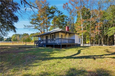 View of front of home featuring covered porch and a chimney