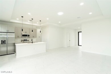 Kitchen featuring a tray ceiling, appliances with
