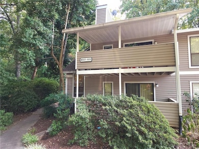Back of property with a balcony and a chimney