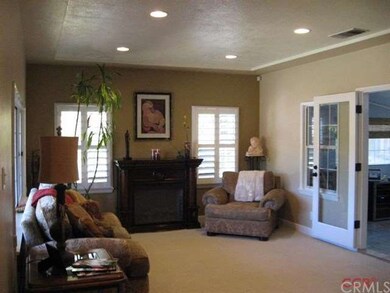 Living room has recessed lighting, and wood shutte