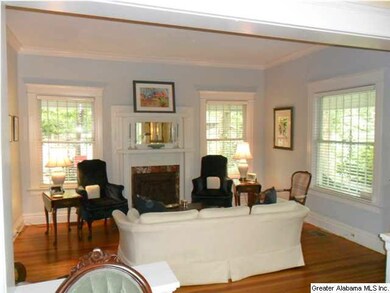 Formal living room with fireplace and pine floors