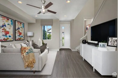 Living area with recessed lighting, dark wood-style floors, stairway, and a ceiling fan