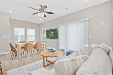 Living room with light wood-type flooring, baseboa