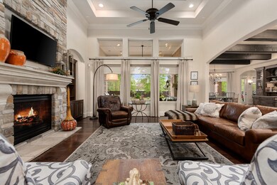 Wall of windows with an exquisite view of the pool and double tray ceiling with crown molding!