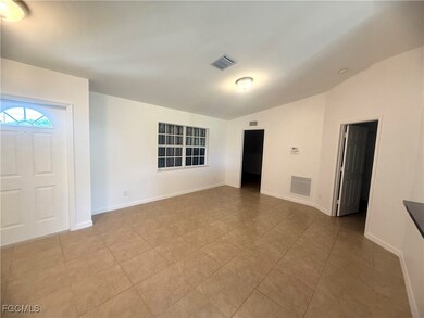 Foyer featuring lofted ceiling and light tile patterned flooring