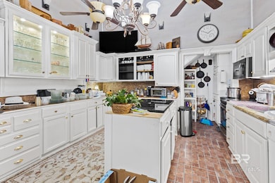 Kitchen featuring white cabinetry, a ceiling fan, decorative backsplash, and open shelves