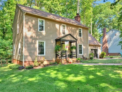 Colonial inspired home featuring a front lawn