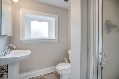 2nd floor full bathroom with pedestal sink and sho