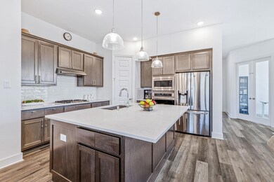 Beautifully stained cabinets in the kitchen add wa