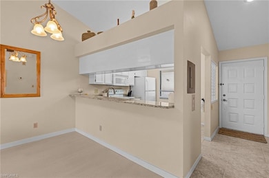 Kitchen featuring hanging light fixtures, vaulted 