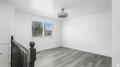 Empty room with wood finished floors and baseboards