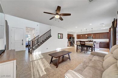 Living room with a ceiling fan, light tile pattern
