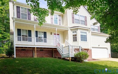 Traditional-style home featuring stairs, a porch, a garage, a front lawn, and driveway