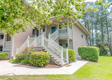 View of home's exterior with a porch, a yard, and 