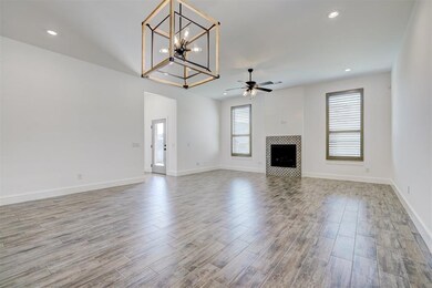Unfurnished living room featuring a fireplace, cei