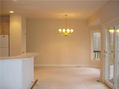 Dining Room. VIEW OF THE FORMAL DINING AREA OFF OF THE KITCHEN AND BREAKFAST BAR. ATRIUM DOORS OPEN  ONTO DECK AND WOODED BACKYARD