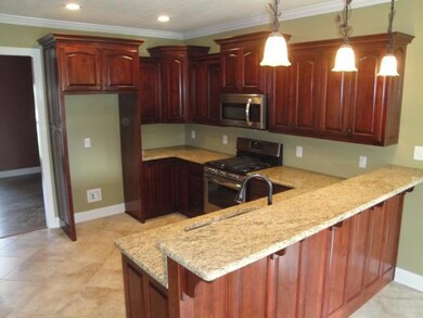 The cook of the family will love  this beautiful kitchen w/ Custom Cabinets , Tiled Flooring, Recessed & Pendant Lighting, Disposal and Stainless Appliances