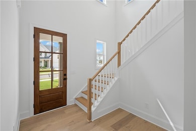 Impressive foyer with a two story ceiling and a statement front door