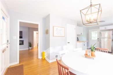 Dining area featuring light wood-style flooring and a chandelier