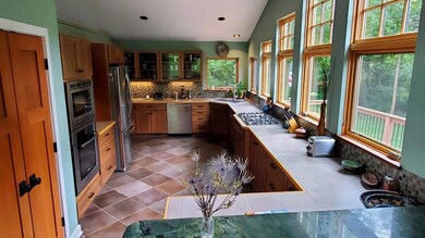 Large Open Kitchen with Efficient Work Triangle, LOTS of LIGHT, Pantry, + Broom Closet.