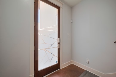This photo shows a modern entryway with a sleek wo