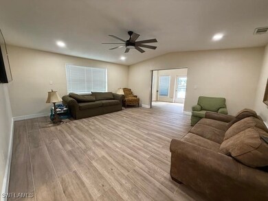 Living room featuring recessed lighting, wood finished floors, vaulted ceiling, and a ceiling fan