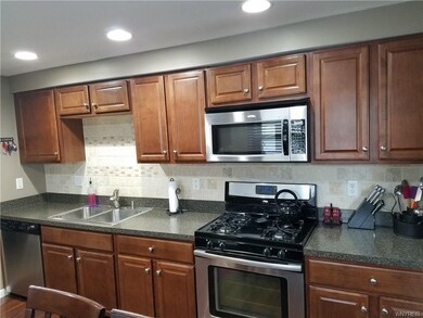 Updated kitchen with mahogany cabinets, tile backs