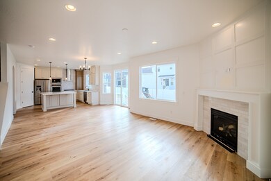 Unfurnished living room featuring recessed lighting, a fireplace, a chandelier, and light wood-type flooring