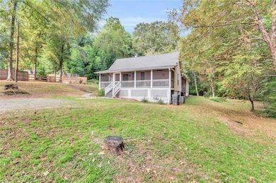 View of front of property with a front lawn and a sunroom
