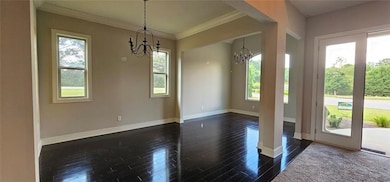 Unfurnished dining area featuring a chandelier, da
