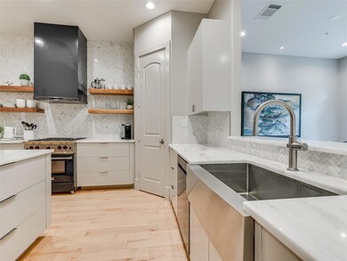 Kitchen featuring exhaust hood, a sink, stainless