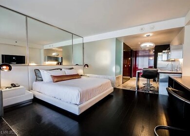 Bedroom with hardwood / wood-style floors and a si