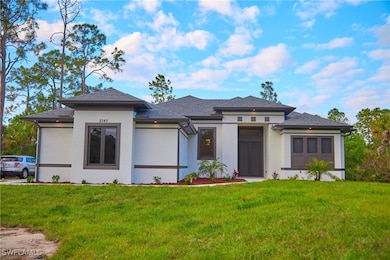 Prairie-style home featuring a front lawn, stucco