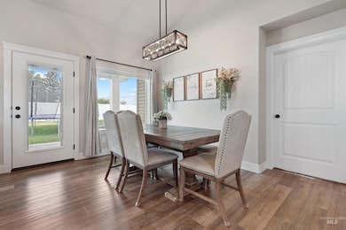 Dining area featuring wood finished floors and a chandelier