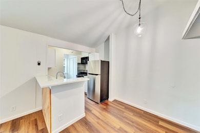 Kitchen featuring freestanding refrigerator, ligh