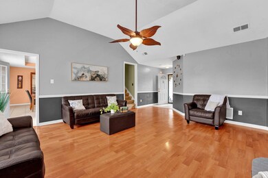 Living room with light wood finished floors, high 