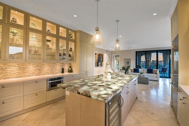 The island kitchen is open to the living room. Dow