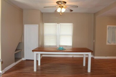 Dining room with new laminate flooring and ceiling fan.