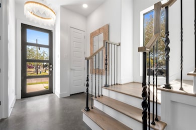 Step into elegance through the formal entry, highlighted by a stunning chandelier and refined finishes. A grand first impression that sets the stage for the home’s luxurious design.