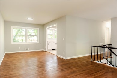 Empty room featuring light wood-type flooring and baseboards