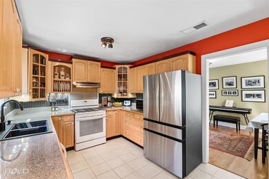 Kitchen with dark stone counters, stainless steel 