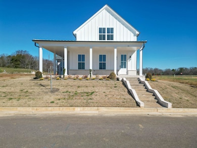 View of front facade featuring brick siding, cover