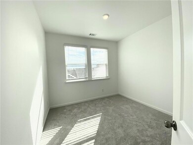 Carpeted empty room with baseboards