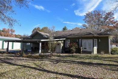 Rear view of property with a lawn, entry steps, french doors, and a patio area