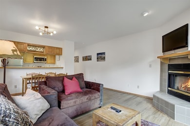 Living area with a tile fireplace, wood finished f