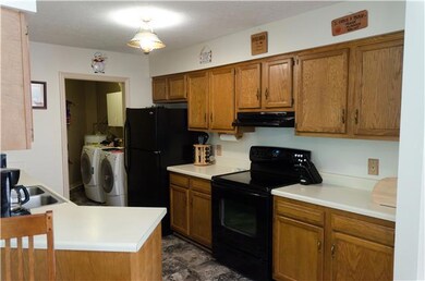 Kitchen is off the garage and is open to the dining area, living room and fireplace.