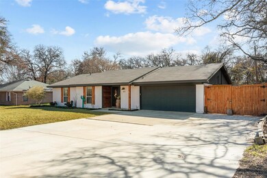 Ranch-style house with a garage and a front yard