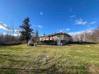 Rear view of property featuring a lawn
