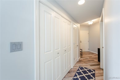 Corridor with baseboards and light wood-style floo