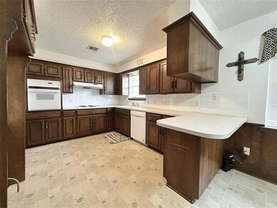 Kitchen with a textured ceiling, kitchen peninsula